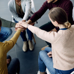 participantes terapia grupo juntando manos unidad sesion centro medico.jpg